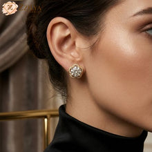 Close-up of a woman wearing a gold solitaire earring by zzilya fashion