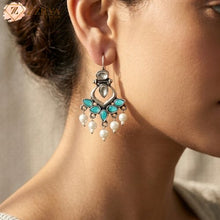 Lightweight turquoise stone oxidised dangle earrings with pearls hangion a on a model, aesthetic daily wear office jewelry from Zzilya Fashion.