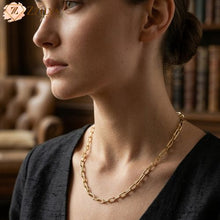 Woman wearing a gold necklace with a blurred background by zzilya fashion